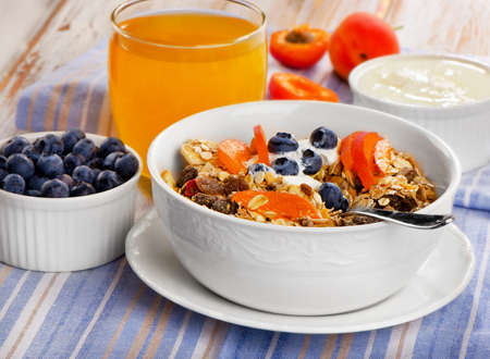 Healthy breakfast - muesli with yogurt and fresh juice   Selective focusの写真素材