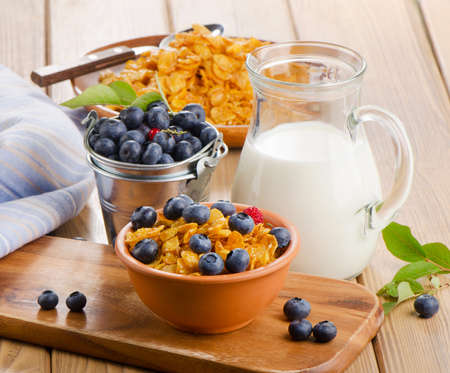 Healthy breakfast - Corn flakes with fresh blueberries and milk. Selective focusの写真素材