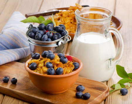 Healthy breakfast - Corn flakes with fresh blueberries and milk. Selective focusの写真素材