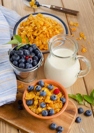 Healthy breakfast - Corn flakes with fresh blueberries and milk. Selective focusの写真素材