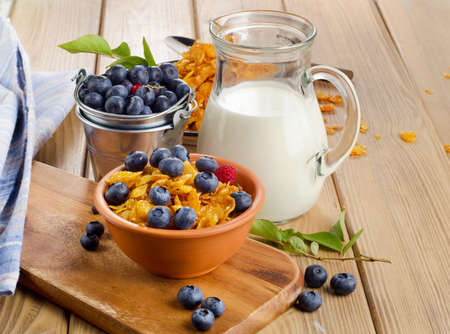 Healthy breakfast - Corn flakes with fresh blueberries and milk. Selective focusの写真素材