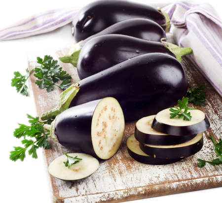 Eggplants on a wooden border isolated on a white backgroundの写真素材