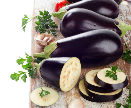Eggplants on a wooden border isolated on a white backgroundの写真素材