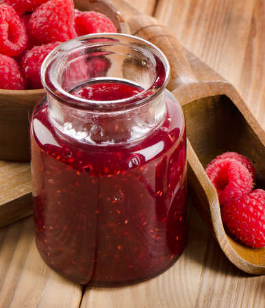 Glass jar of jam with fresh raspberries . Selective focusの写真素材