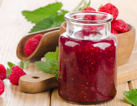 Glass jar of jam with fresh raspberries  .Selective focusの写真素材