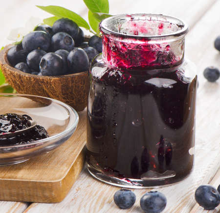 Fresh blueberries jam in a glass  jar. Selective focusの写真素材