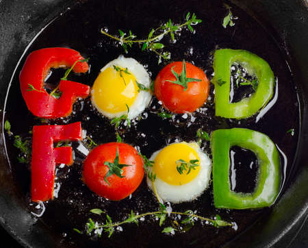 Fried vegetables and eggs with herbs  in pan の写真素材