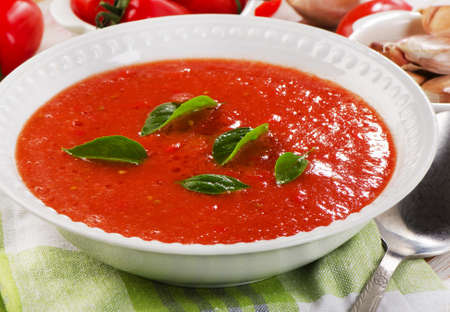Fresh tomato soup in a white bowl on a wooden table  Selective focusの写真素材