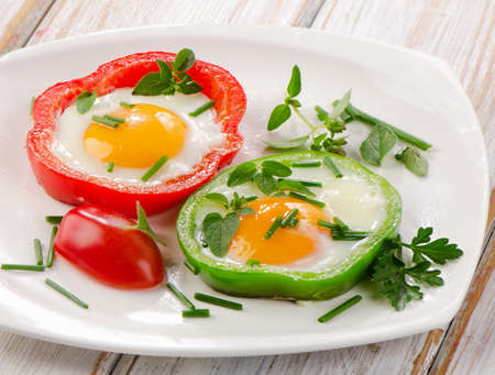 Healthy breakfast - fried eggs with herbs and paprika   Selective focusの写真素材