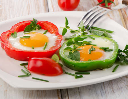 Healthy breakfast - fried eggs with herbs and paprika   Selective focusの写真素材