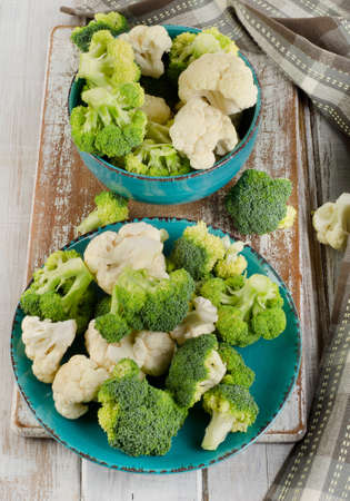 Fresh green broccoli and  cauliflower on a  wooden table. Selective focusの写真素材