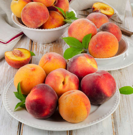 Fresh peaches on a wooden table  Selective focusの写真素材