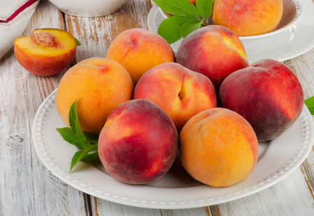 Fresh peaches on a wooden table  Selective focusの写真素材