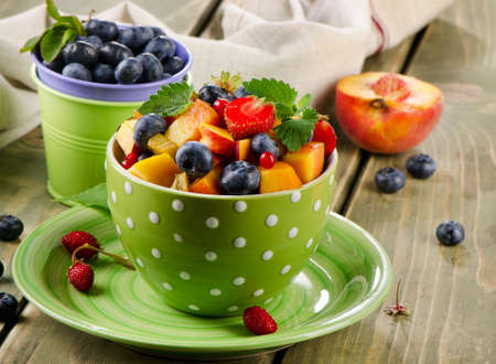 Fresh healthy fruit salad on a wooden table. Selective focusの写真素材