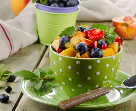 Fresh healthy fruit salad on a wooden table. Selective focusの写真素材