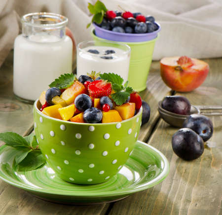 Healthy breakfast - fresh fruit salad and yogurt. Selective focusの写真素材