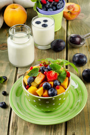 Healthy breakfast - fresh fruit salad and yogurt. Selective focusの写真素材