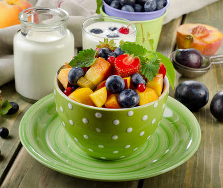 Healthy breakfast - fresh fruit salad and yogurt. Selective focusの写真素材