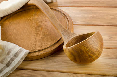 Napkin with wooden spoon on a  wooden tableの写真素材
