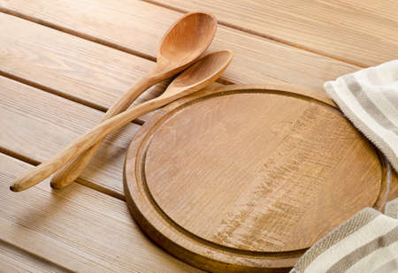 Napkin with wooden spoon on a  wooden tableの写真素材