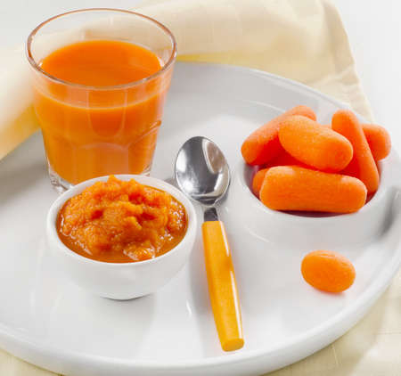 Baby healthy  food -  pureed carrot and juice. Selective focusの写真素材