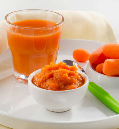 Baby healthy  food -  pureed carrot and juice. Selective focusの写真素材