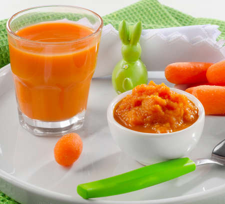 Baby healthy  food -  pureed carrot and juice. Selective focusの写真素材