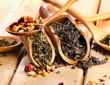 Assortment of dry tea in spoon on a  wooden background. Selective focusの写真素材