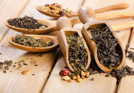 Assortment of dry tea in spoon on a  wooden background. Selective focusの写真素材