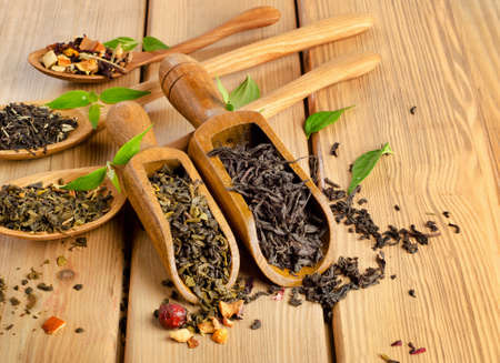 Assortment of dry tea in spoon on a  wooden background. Selective focusの写真素材