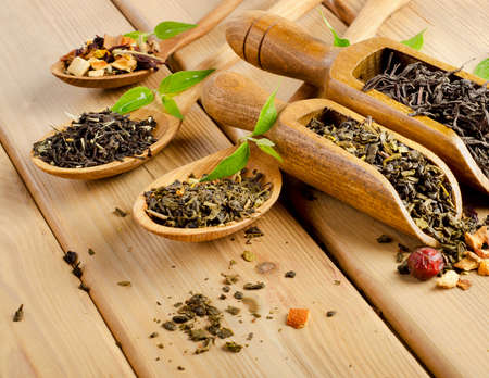 Assortment of dry tea in spoon on a  wooden background. Selective focusの写真素材