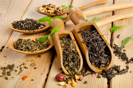 Assortment of dry tea in spoon on a  wooden background. Selective focusの写真素材
