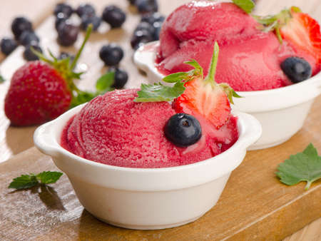 Ice cream   with fresh berries and mint. Selective focusの写真素材