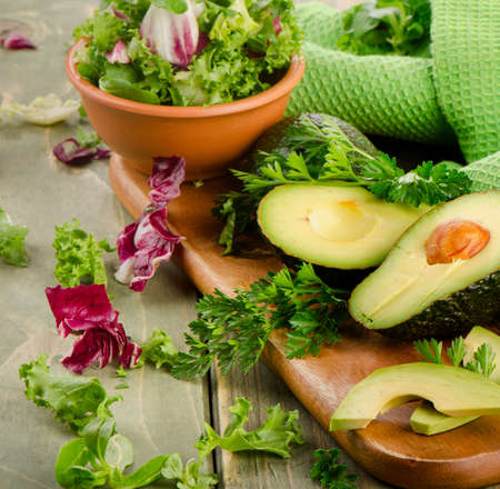 Lettuce salad and fresh avocado on a wooden table. Selective focusの写真素材