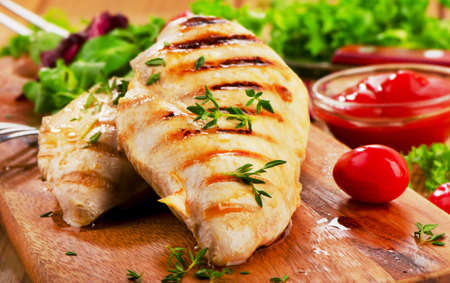 Grilled chicken breast with fresh vegetables . Selective focusの写真素材