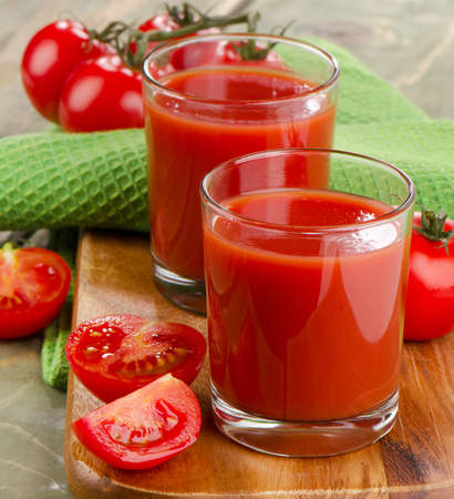 Tomato juice with fresh tomatoes and herbs . Selective focusの写真素材