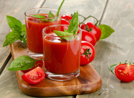 Tomato juice with fresh tomatoes and herbs . Selective focusの写真素材