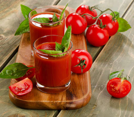 Tomato juice with fresh tomatoes and herbs . Selective focusの写真素材