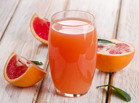Fresh grapefruit juice  on a wooden table. Selective focusの写真素材