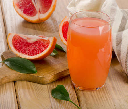 Grapefruit juice and  grapefruits on a wooden table. Selective focusの写真素材