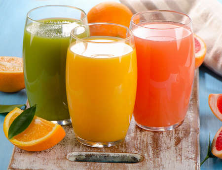 Fresh citrus juices in glasses. Selective focusの写真素材