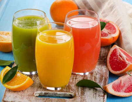 Fresh citrus juices in glasses. Selective focusの写真素材