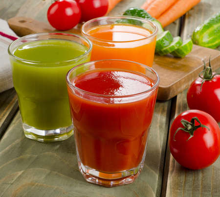 Healthy vegetable  juices on a wooden table. Selective focusの写真素材