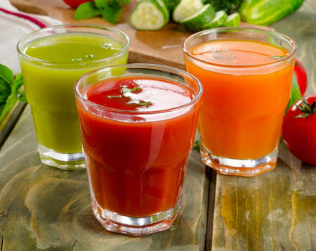 Healthy vegetable  juices on a wooden table. Selective focusの写真素材
