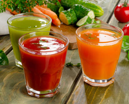 Healthy vegetable  juices on a wooden table. Selective focusの写真素材