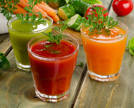 Healthy vegetable  juices on a wooden table. Selective focusの写真素材