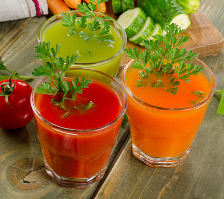Fresh healthy vegetable  juices on a wooden table. Selective focusの写真素材