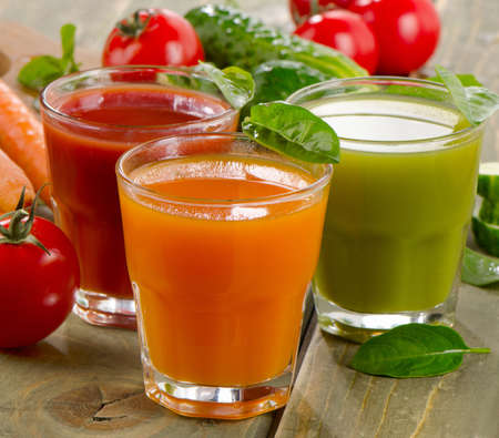 Healthy vegetable  juices on a wooden table. Selective focusの写真素材
