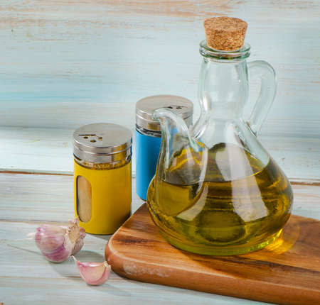Olive oil and spices on a wooden table. Selective focusの写真素材