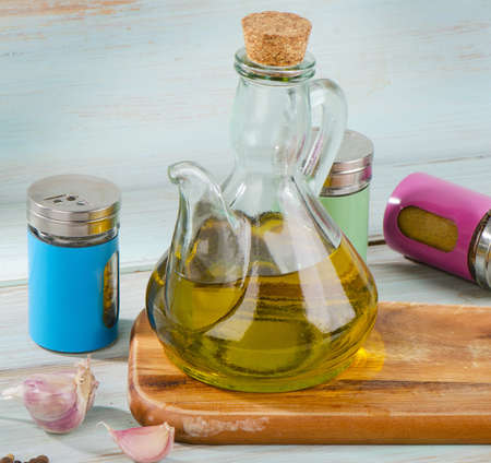 Olive oil and spices on a wooden table. Selective focusの写真素材